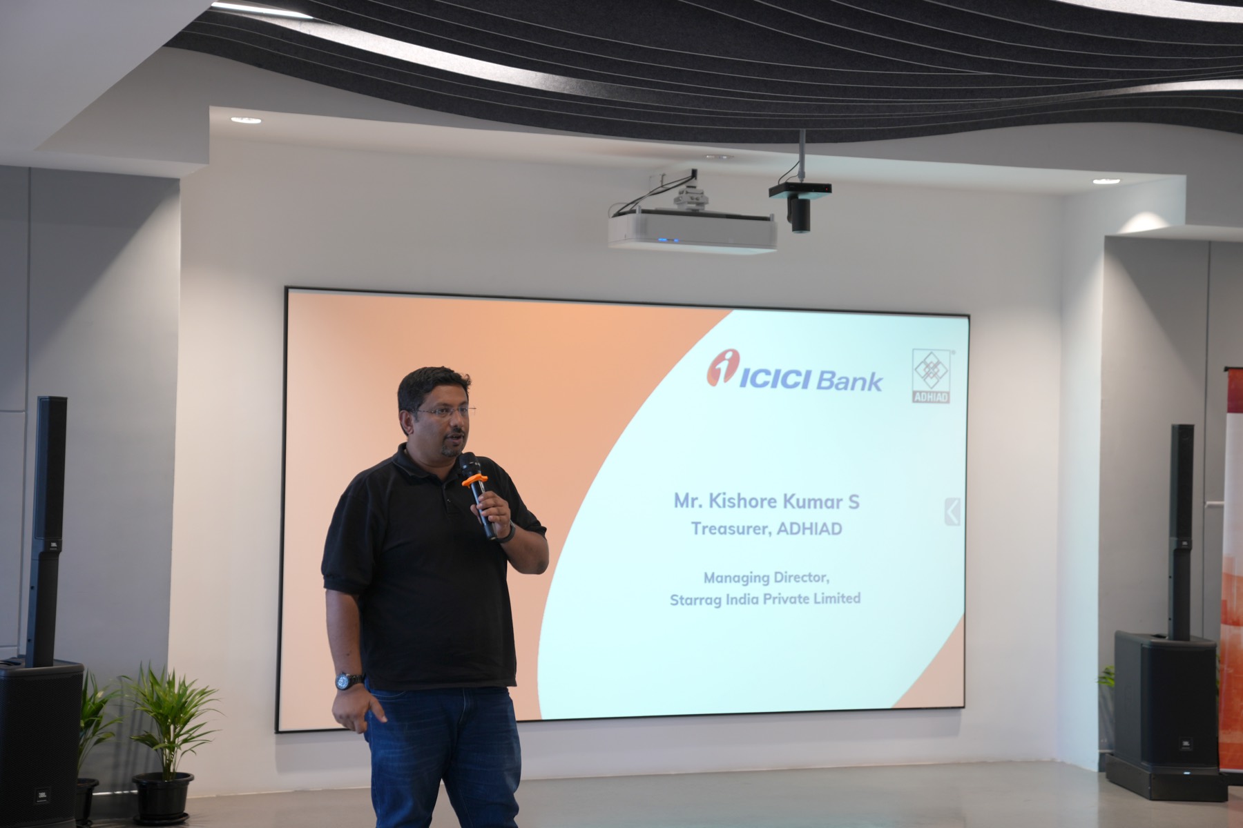 A speaker addresses the June 15th session beneath the ICICI Bank and ADHIAD welcome screen.